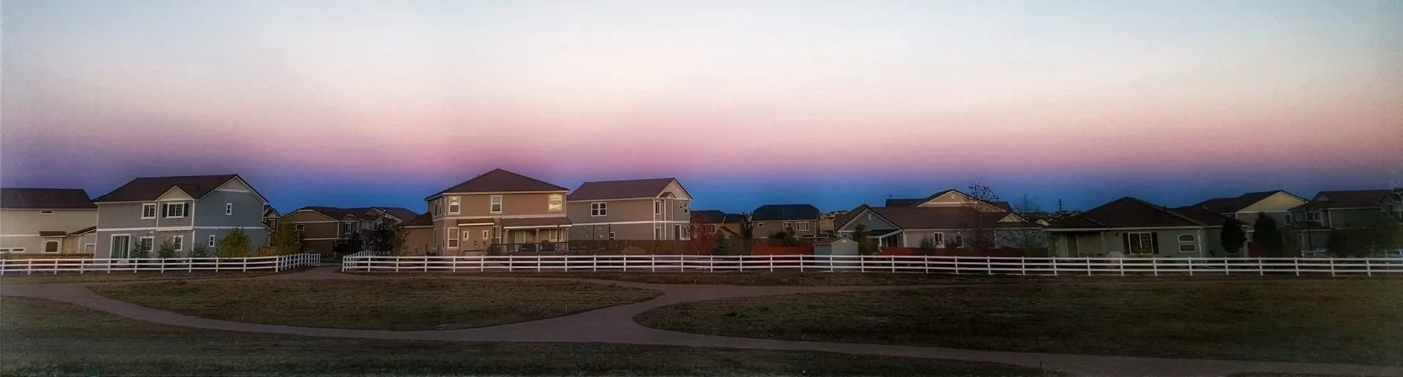 Feathergrass homes overlooking the community park at dusk